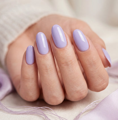 Hand with lavender nail polish on a neutral background