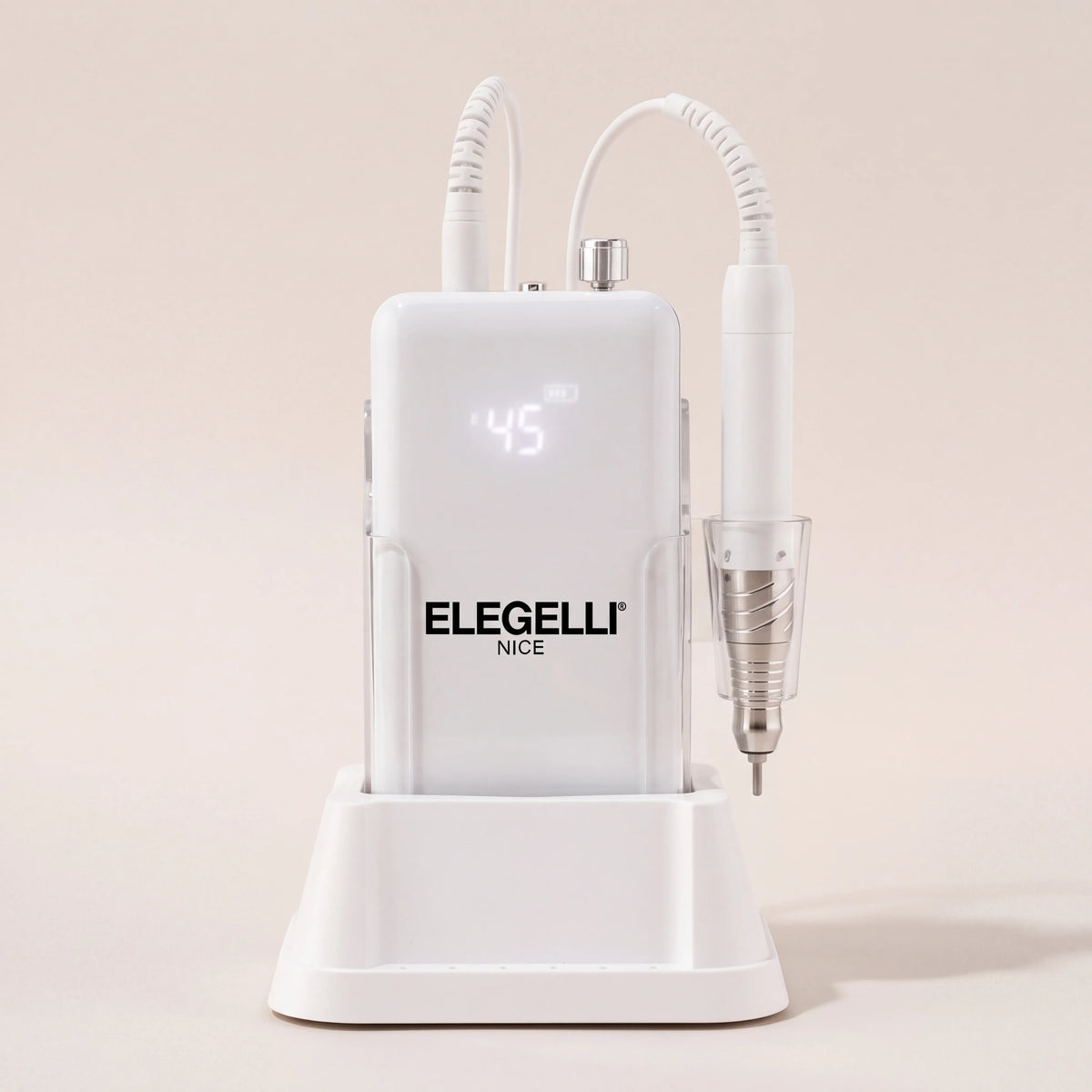 A white Elegelli professional nail drill machine with a digital display and an attached white rotary burr pen, resting on its matching white charging stand against a warm beige background.
