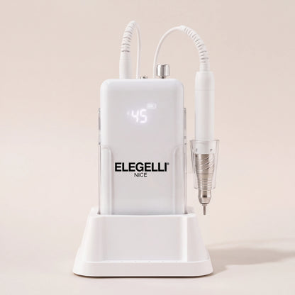 A white Elegelli professional nail drill machine with a digital display and an attached white rotary burr pen, resting on its matching white charging stand against a warm beige background.