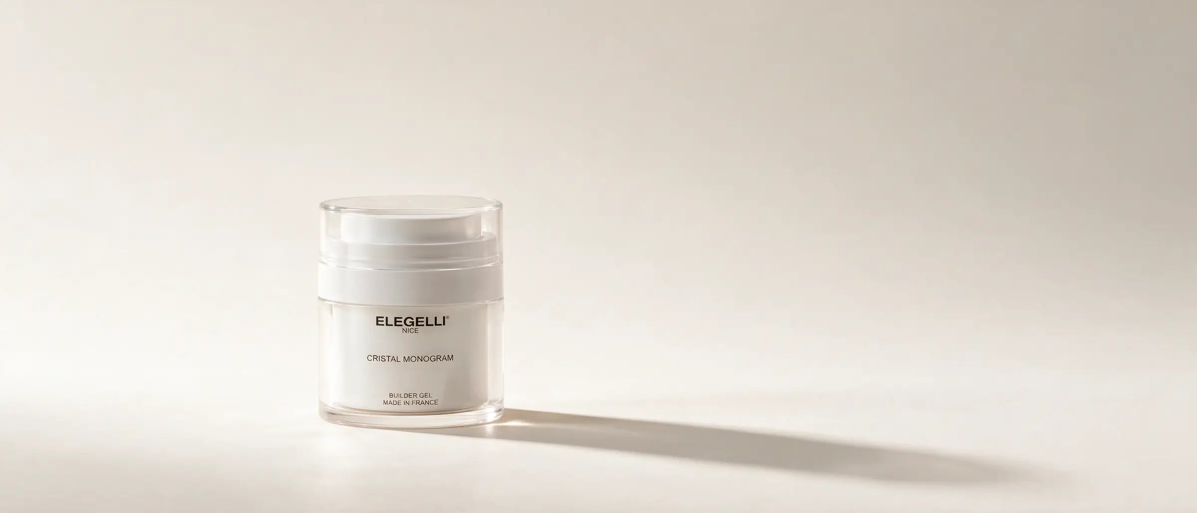 The Elegelli builder gel jar standing alone on a warm porcelain studio sweep